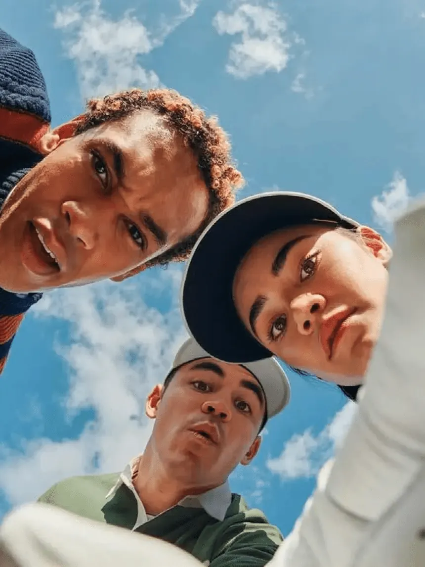 Three friends looking up at the camera